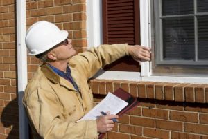 Home inspector examining window.